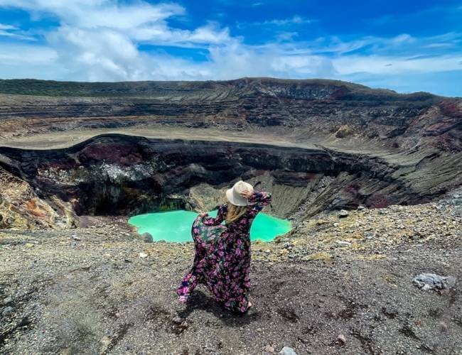 santa ana volcano tour hike el salvador, woman wearing a colorful dress, standing in front of a crater - top things to do in el salvador-1